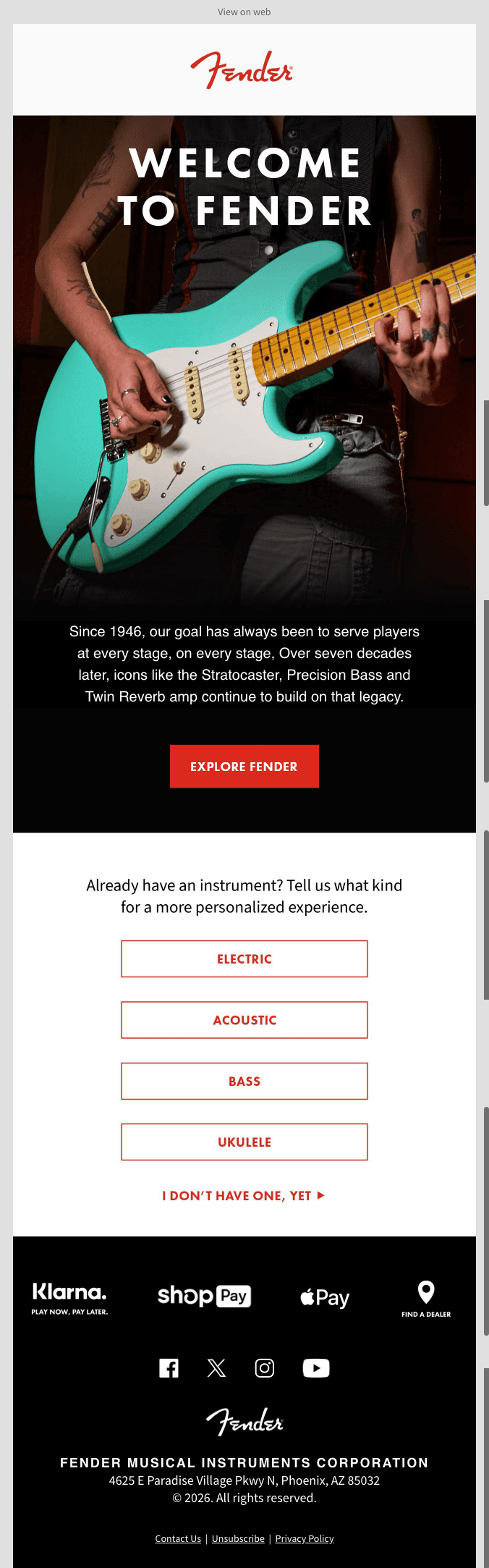 Fender logo at top. Below, a photo of a tattooed guitarist holding a teal Stratocaster, with white text reading "Welcome to Fender." A black button reads "EXPLORE FENDER." Body copy: "Since 1946, our goal has always been to serve players at every stage, on every stage. Over seven decades later, icons like the Stratocaster, Precision Bass and Twin Reverb amp continue to build on that legacy." Below, a prompt reads "Already have an instrument? Tell us what kind for a more personalized experience," with buttons for Electric, Acoustic, Bass, Ukulele, and I Don't Have One Yet. Klarna and Shop Pay logos follow. Footer shows social icons, Fender logo, address, and links for Contact Us, Unsubscribe and Privacy Policy.