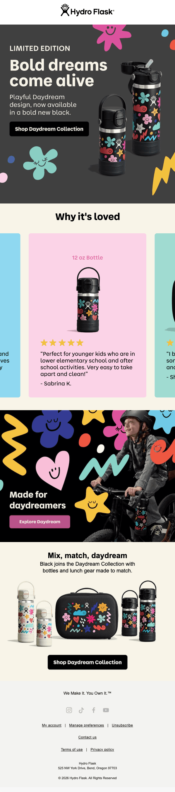 Hydro Flask logo at top. Hero on dark gray with colorful smiley doodle shapes reads "LIMITED EDITION, Bold dreams come alive. Playful Daydream design, now in a bold new black" above a button "Shop Daydream Collection," beside two black bottles with colorful smiley patterns. A "Why it's loved" section shows a black 12 oz bottle with a five-star review from Sabrina K. calling it easy to take apart and clean. A lifestyle photo shows a child biking with a Daydream bottle attached, reading "Made for daydreamers" above a button "Explore Daydream." A product lineup shows cream and black bottles plus a matching lunch bag, with copy "Mix, match, daydream" above a button "Shop Daydream Collection." Footer includes the tagline "We Make It. You Own It," social icons, and Hydro Flask's Bend, Oregon address.